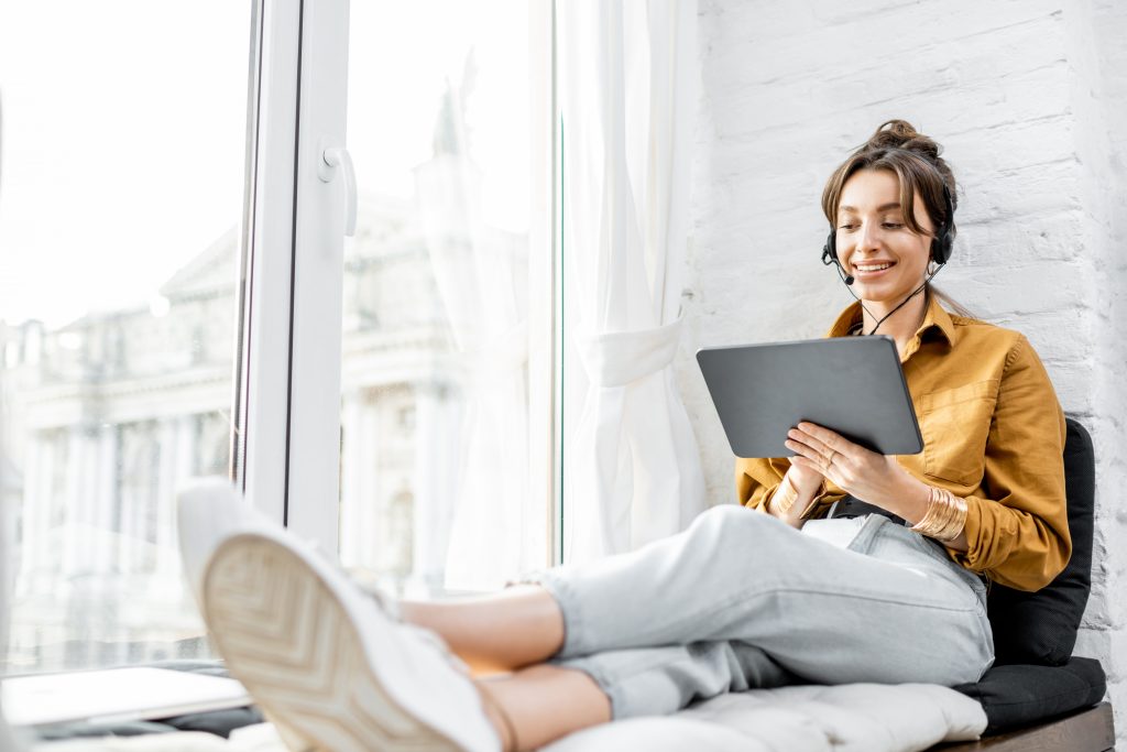 Woman learning online on the window sill